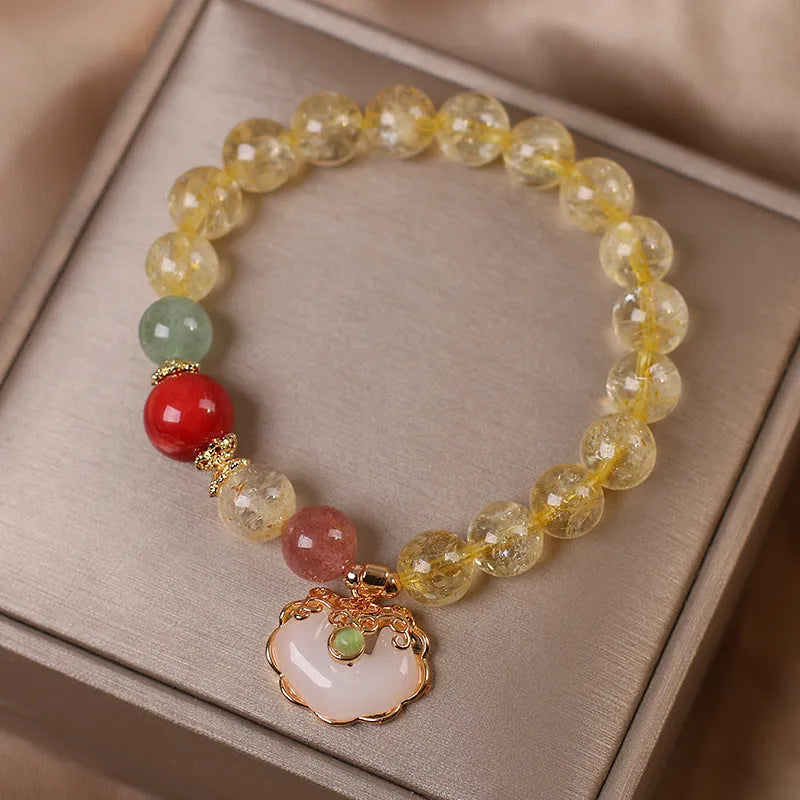 Women's yellow hair crystal jade ruyi pendant bracelet on an alloy chain.
