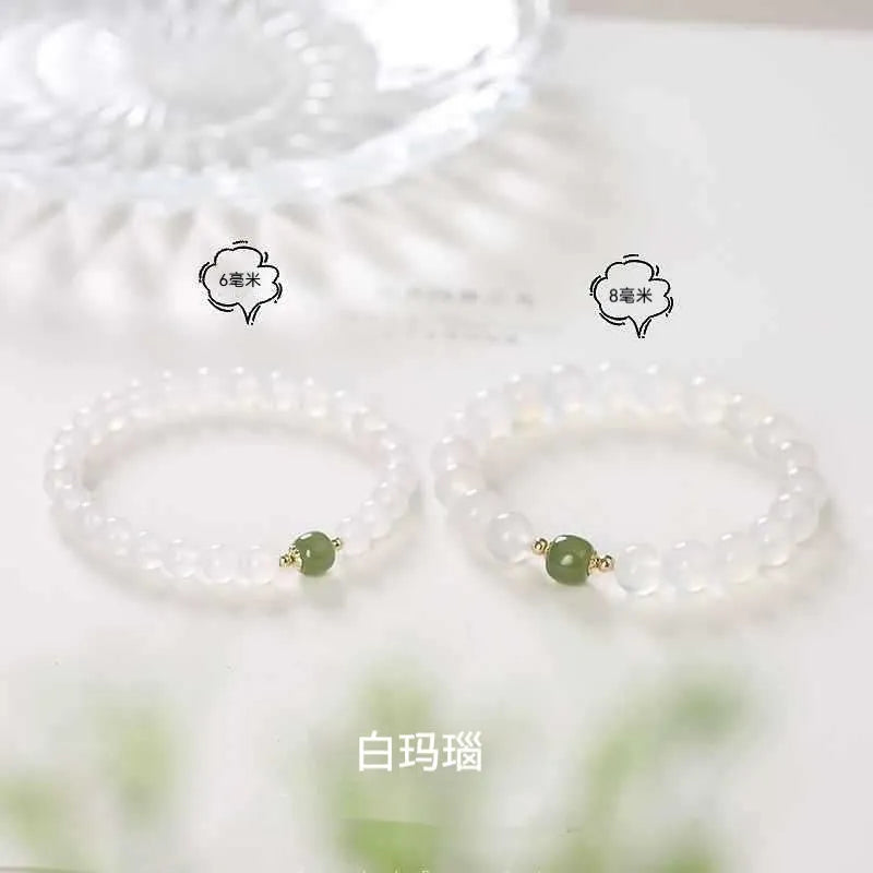 Handmade white agate crystal bracelet with cinnabar accents showing 6mm and 8mm bead sizes