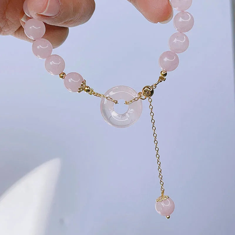 Crystal safety buckle bracelet for women in pink with peace buckle design on white background