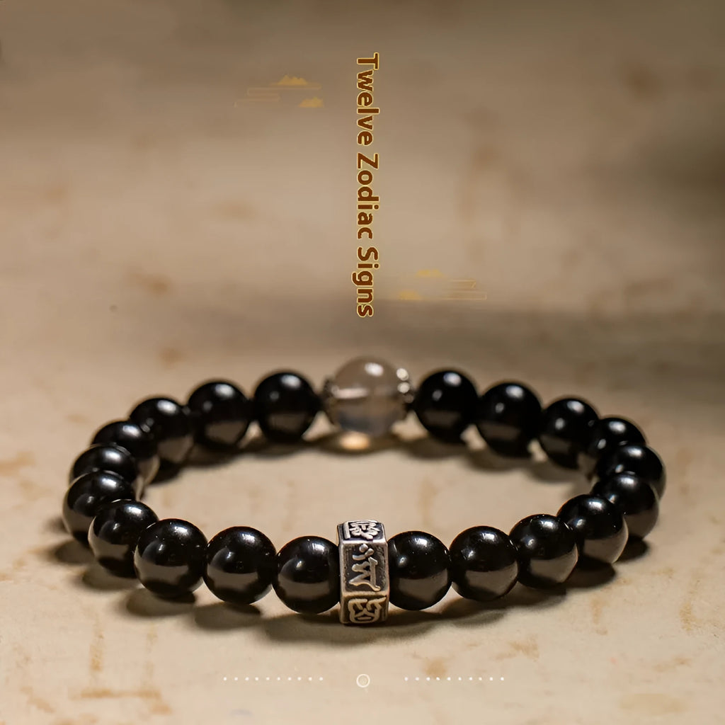 An ethnic-style women's bracelet made from 8mm obsidian beads with zodiac animal and Buddhist bodhisattva charms.