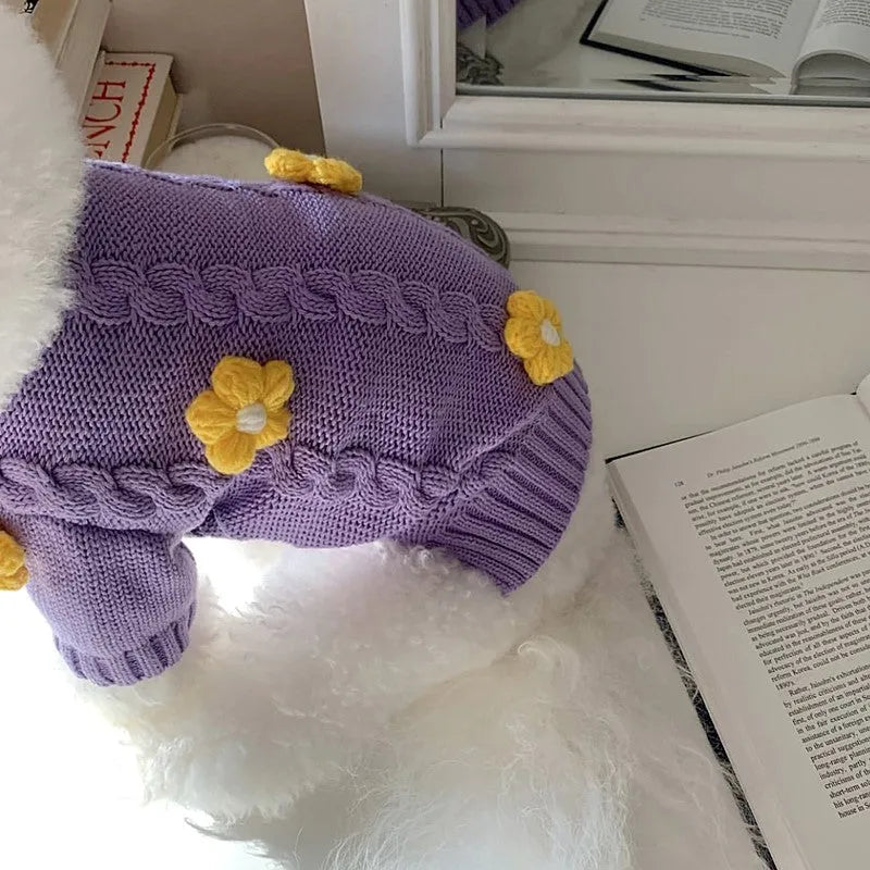 Purple knitted flower print dog clothes with size options from XS to XL on a plain background