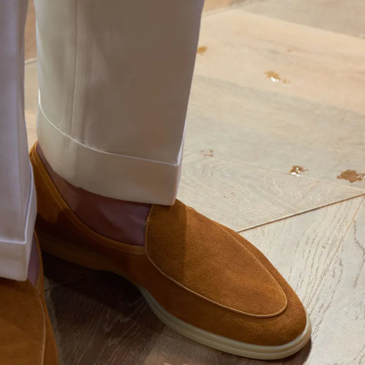 British handmade brown leather loafers for men on a white background.