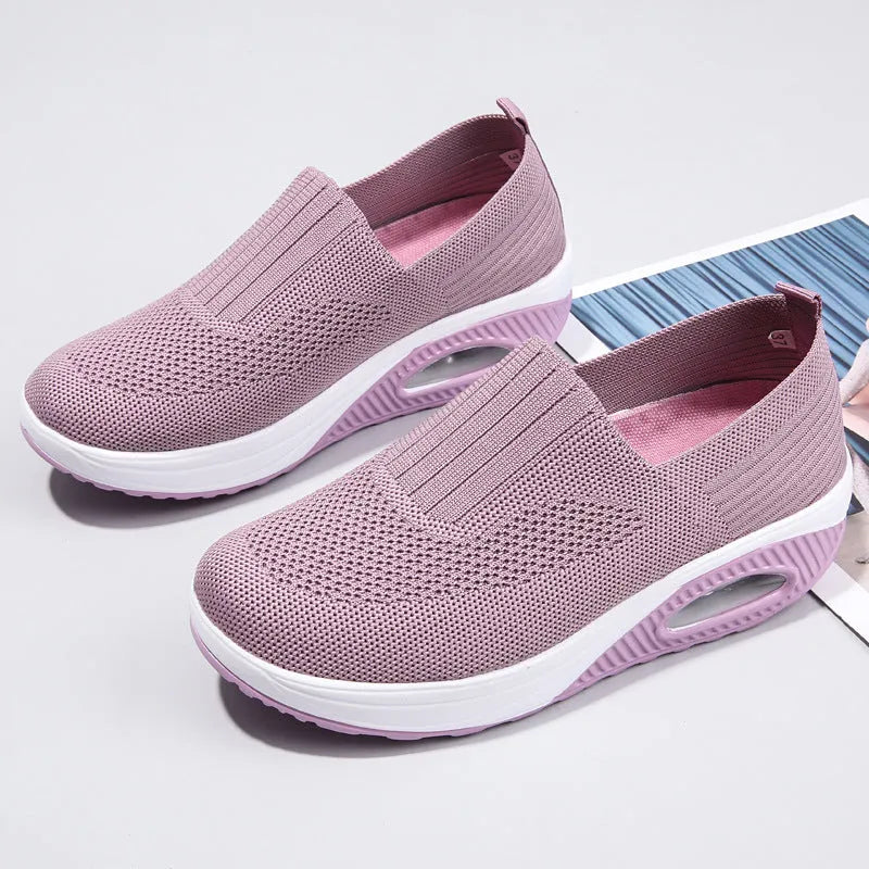 Women's beige mesh running shoes with air cushion midsole on a neutral background.