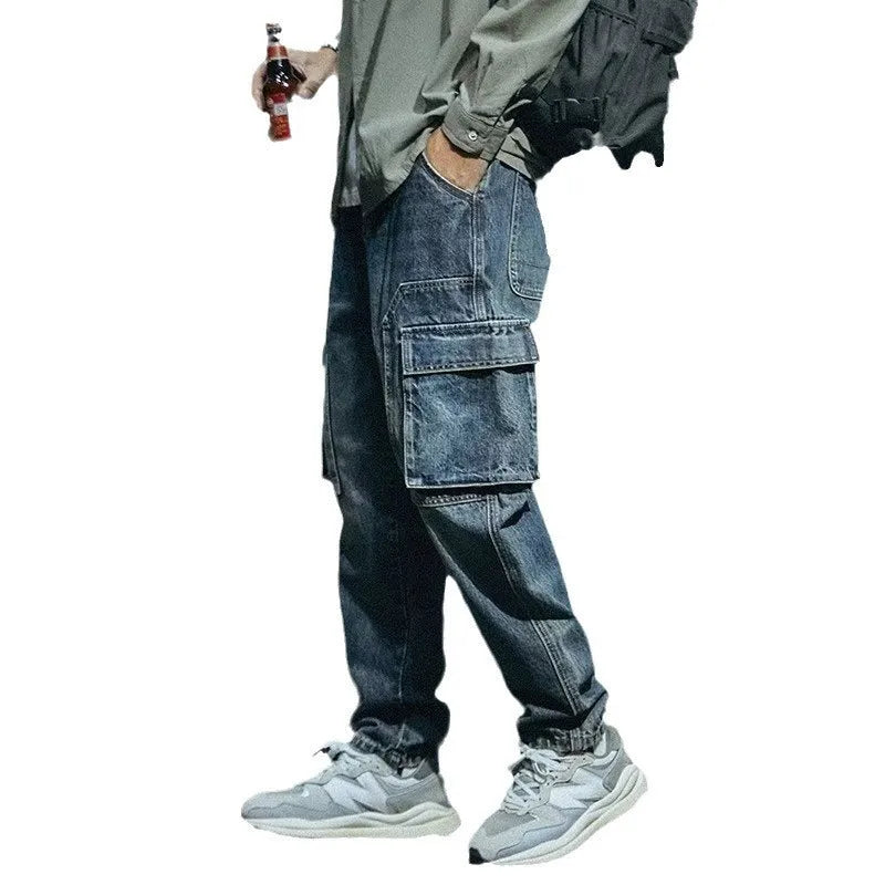 Man wearing blue loose straight-leg denim jeans with a zip fly, casual style.