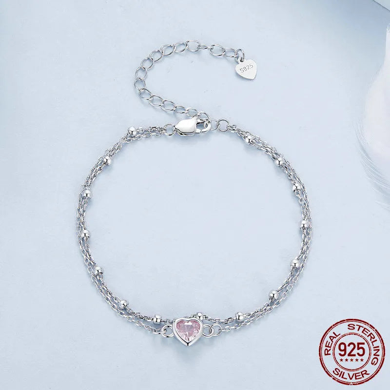 Sweet girlish heart-shaped sterling silver bracelet with adjustable chain on a white background.
