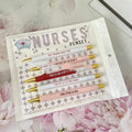 Set of five blue and pink nurse-themed retractable ballpoint pens on a white background.