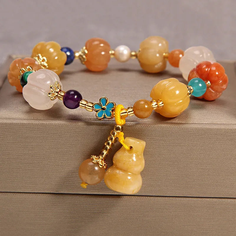 Women's yellow agate crystal bracelet with adjustable gold silk cord on wrist