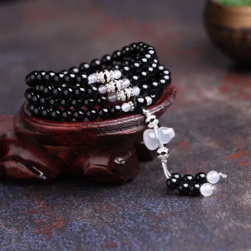 Natural black agate 108 beads bracelet on a flat surface, geometric beads, unisex fashion OL style