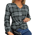 Women's loose-fit purple plaid casual shirt with long sleeves on a hanger.