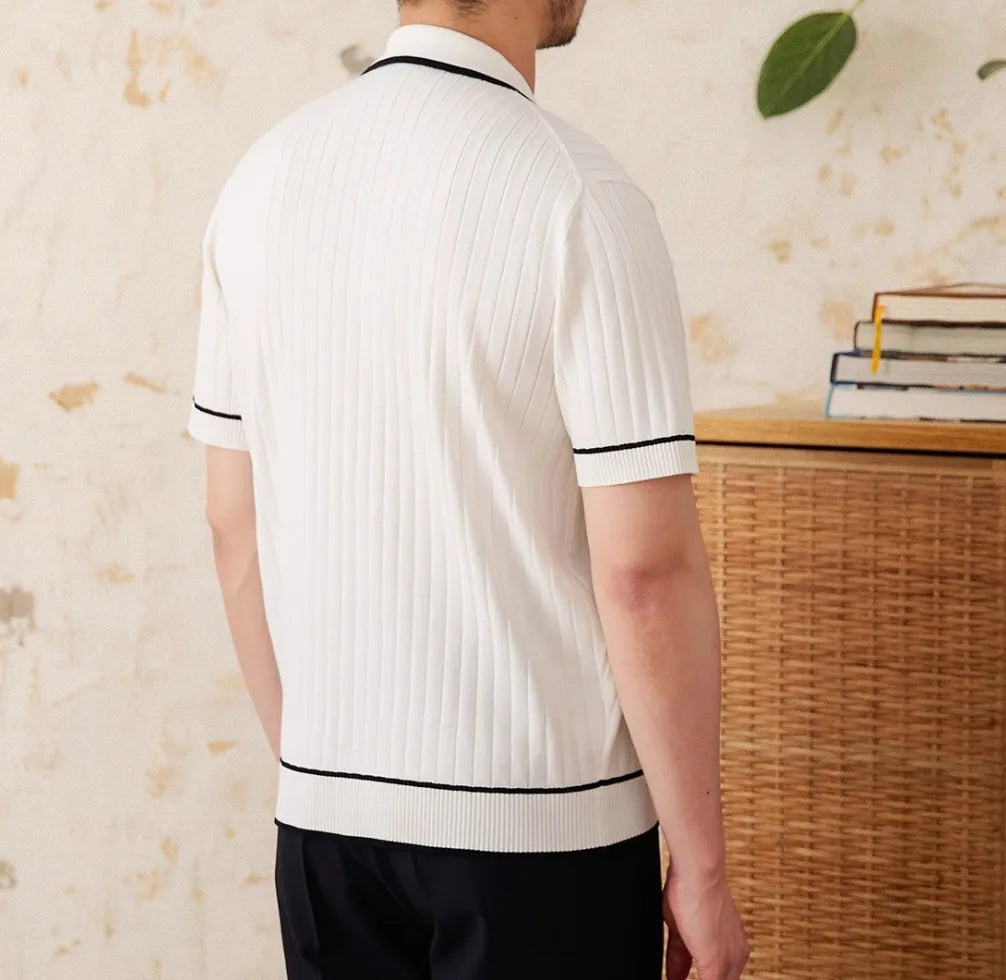 Slim fit black short-sleeved polo shirt with a lapel collar, made from a viscose and polyester knit fabric.