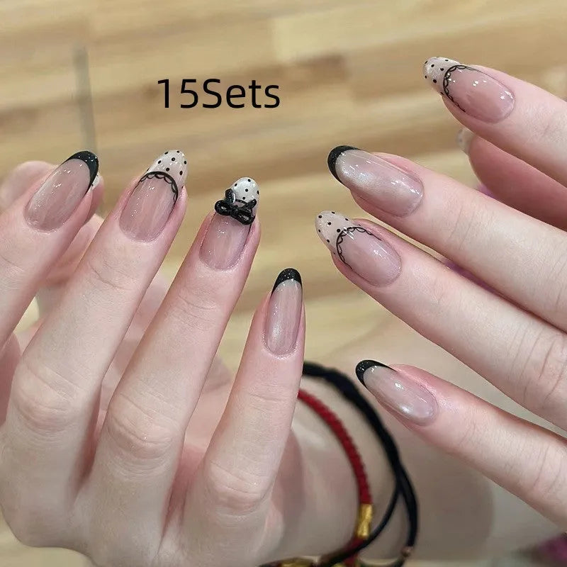 Set of short, colourful fake nails for girls with adhesive tabs on a pink background.