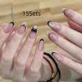 Set of short, colourful fake nails for girls with adhesive tabs on a pink background.
