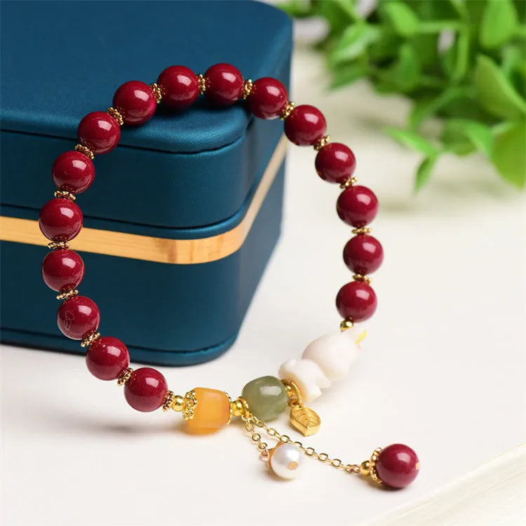 Women's bracelet with natural beeswax, purple gold sand beads, and a red cinnabar rabbit charm.