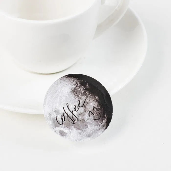 Box of 45 black moon phases and calendar planet stickers on self-adhesive paper