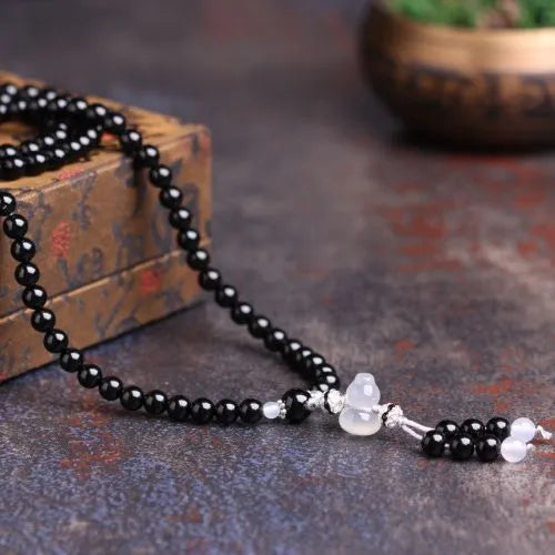 Natural black agate 108 beads bracelet on a flat surface, geometric beads, unisex fashion OL style