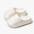 Women's beige fish mouth slippers with a thick 5.5cm light-coloured EVA sole on a wooden floor.