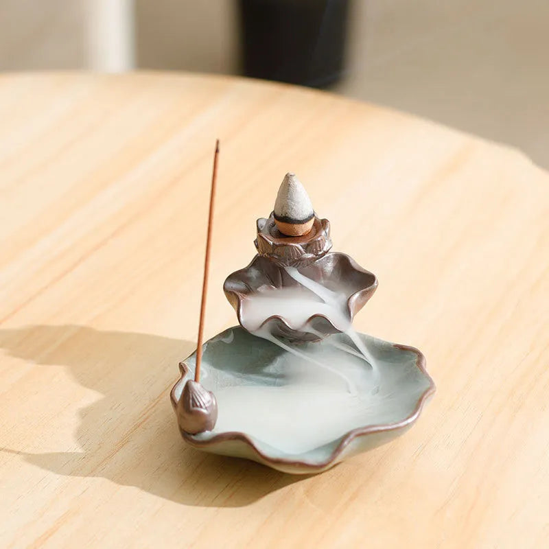 Square ceramic reverse flow incense burner with purple clay finish and lotus plum blossom decoration.