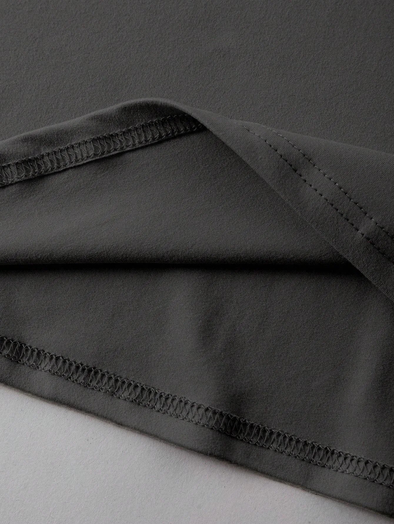 Loose fit short sleeve cotton t-shirt in black on a hanger, showing round neck collar.