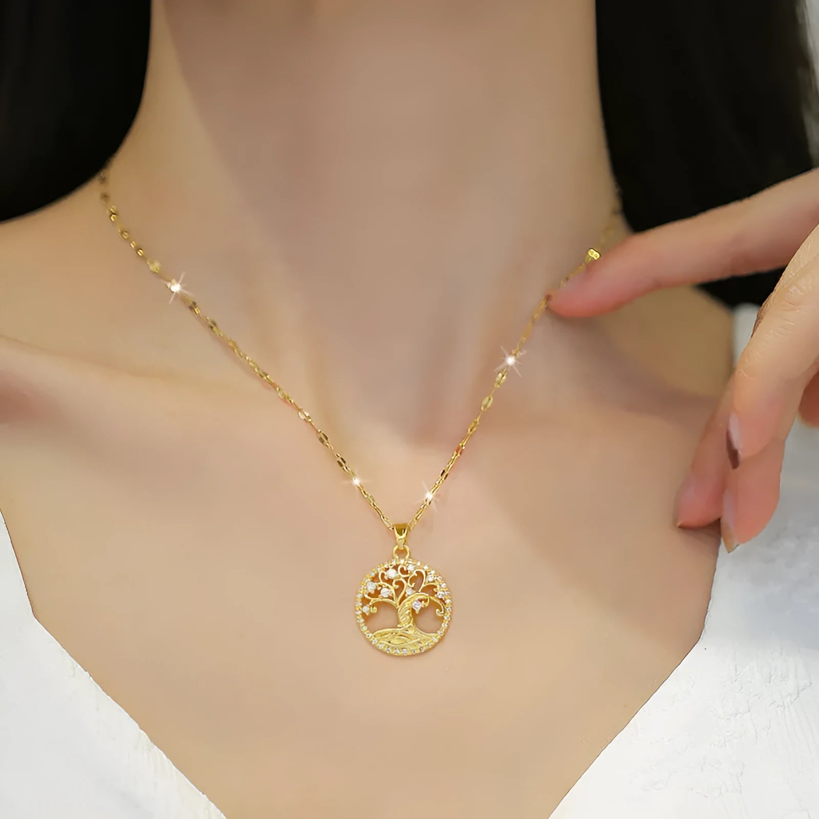 Gold-plated necklace with rhinestone lucky tree pendant featuring mother-of-pearl shell accents on stainless steel chain