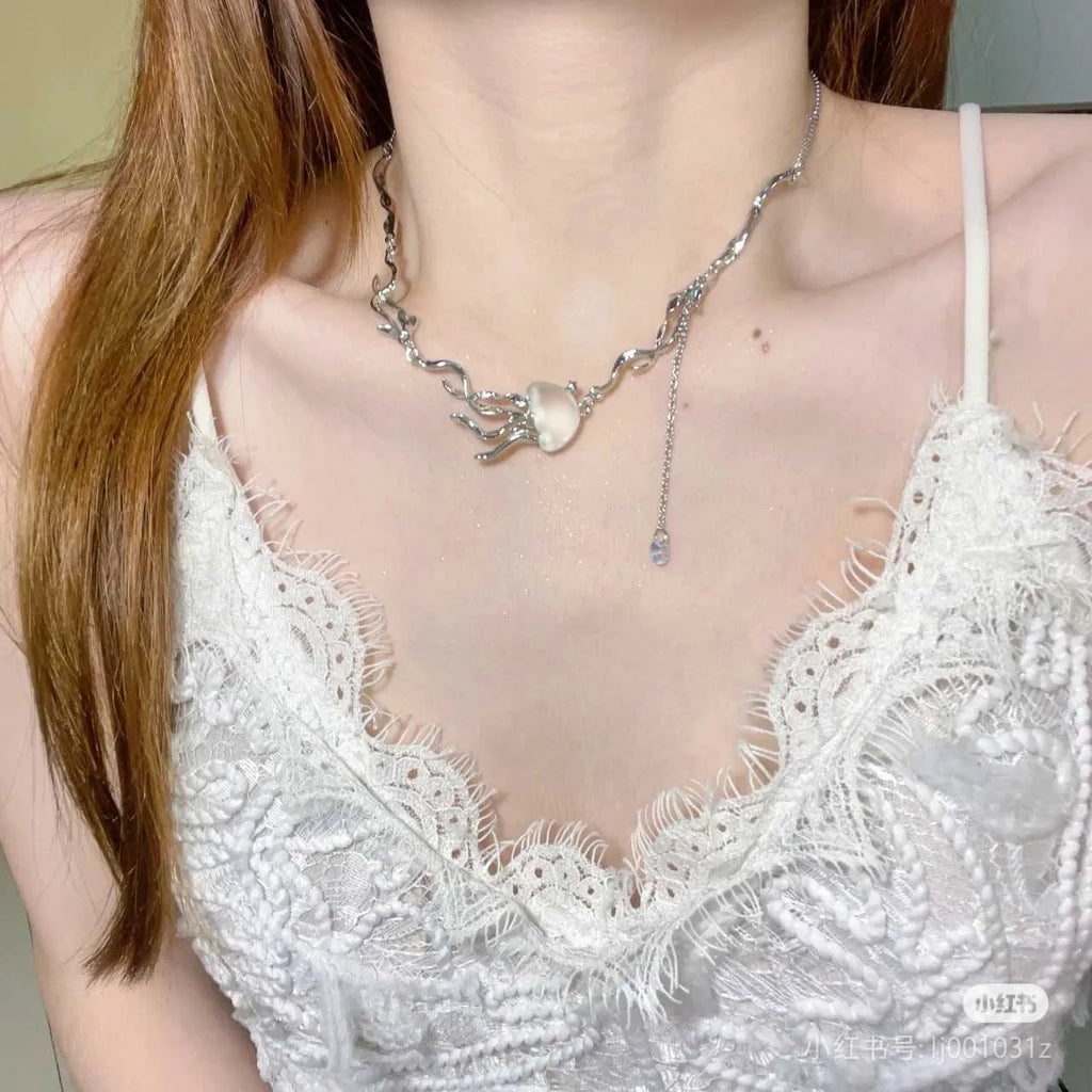 Frosted jellyfish pendant necklace and earrings in multiple colour options on a white background