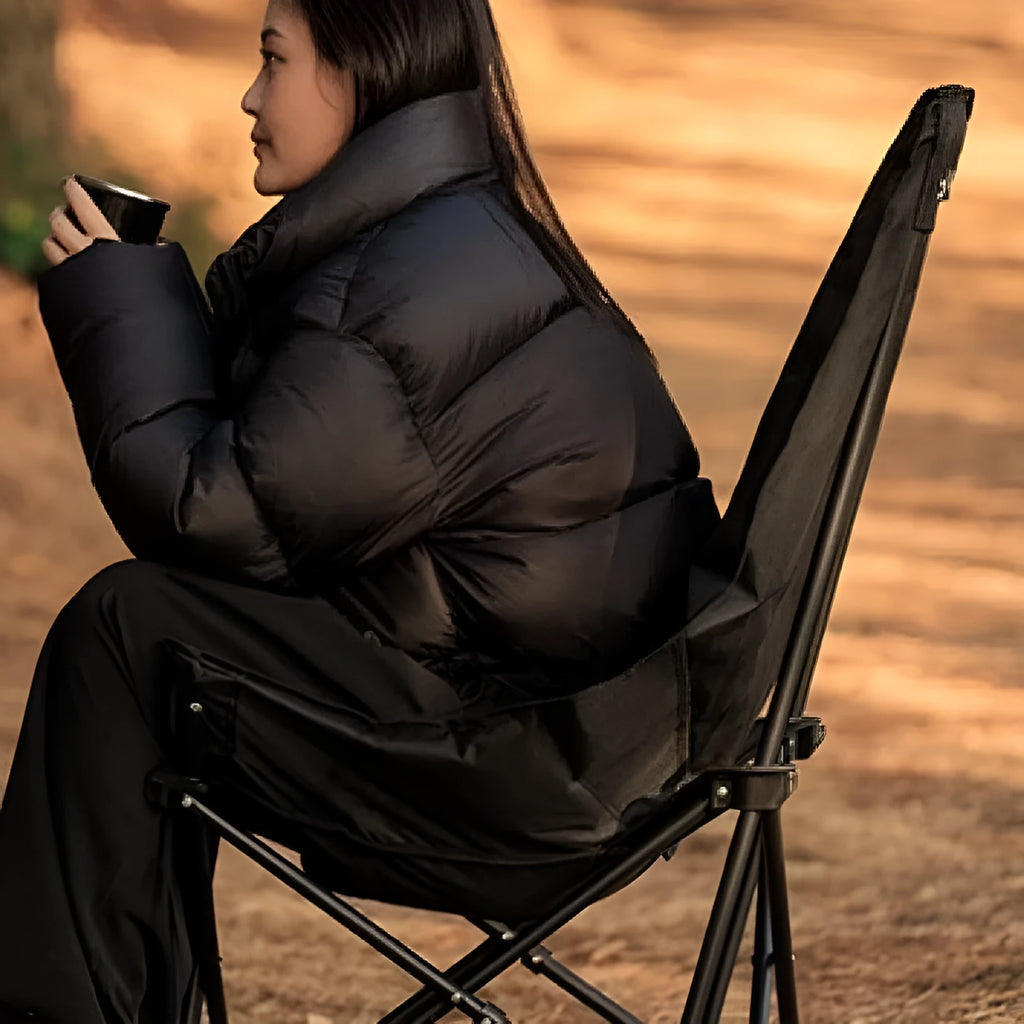 Night Black Oxford cloth portable folding camping recliner chair on grass.