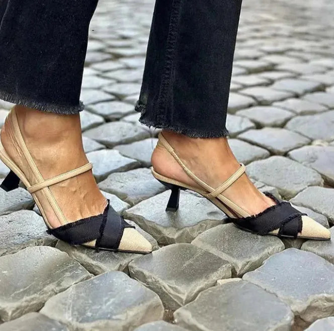 Women's apricot and black colour block pointed toe sandals with a stiletto heel and buckle strap.