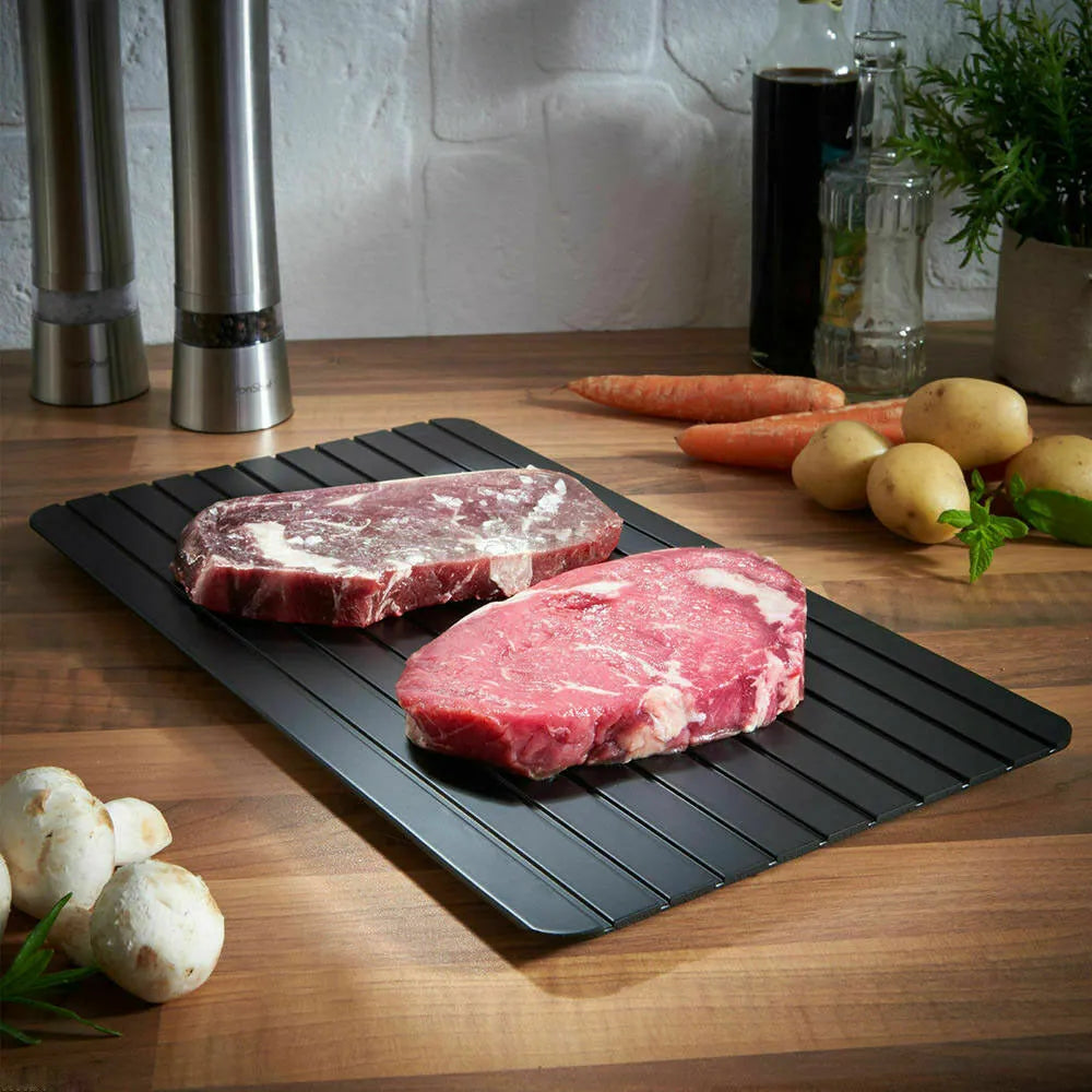 Black aluminium fast defrost tray 23x16.5cm on a countertop