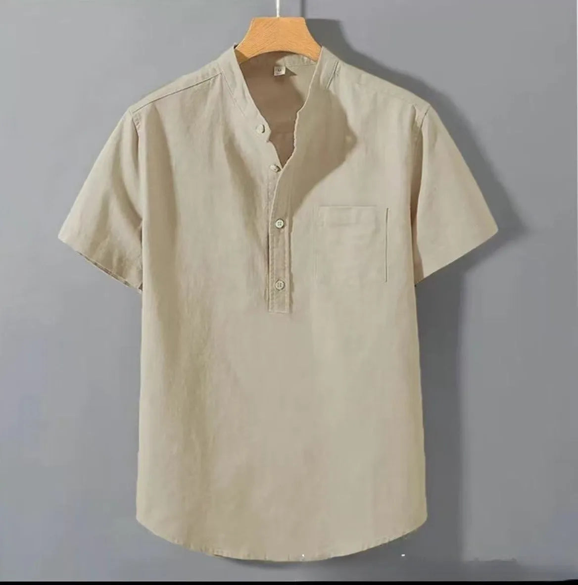 Man wearing a beige casual linen-blend shirt with a stand collar and short sleeves.
