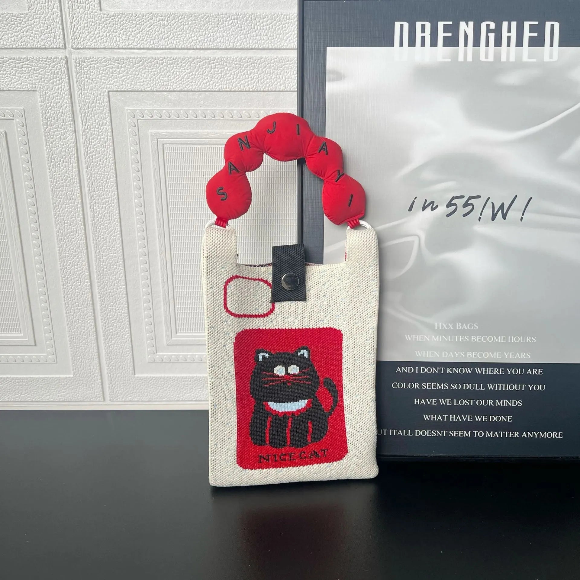 Cute cartoon knitted polyester messenger bag in square vertical shape with single shoulder strap, featuring an open pocket and mobile phone pocket.
