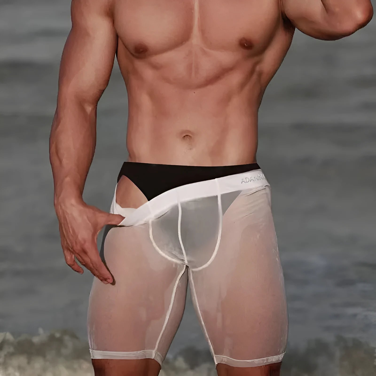 Men's black mesh nylon shorts with seamless knit construction for home lounging.