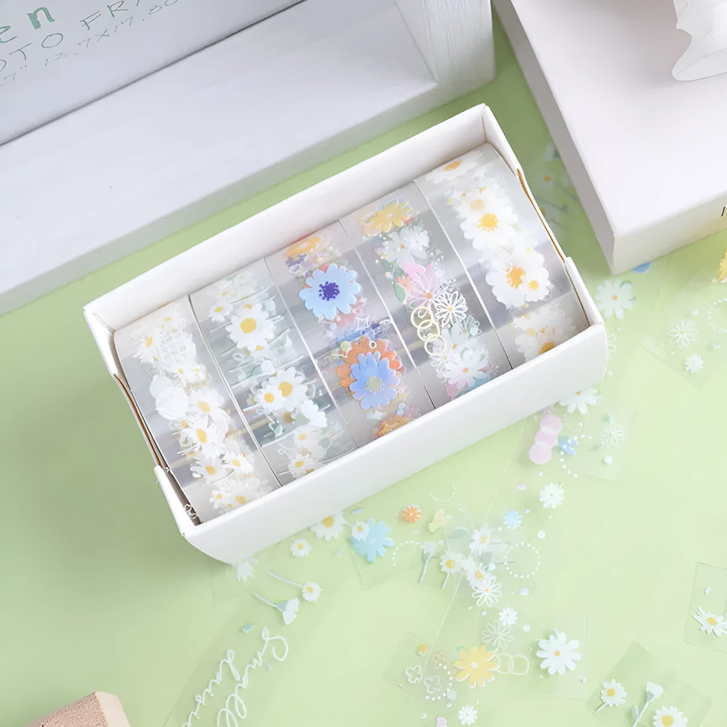 Five rolls of transparent adhesive tape with yellow and white daisy cartoon pattern on a clear background.