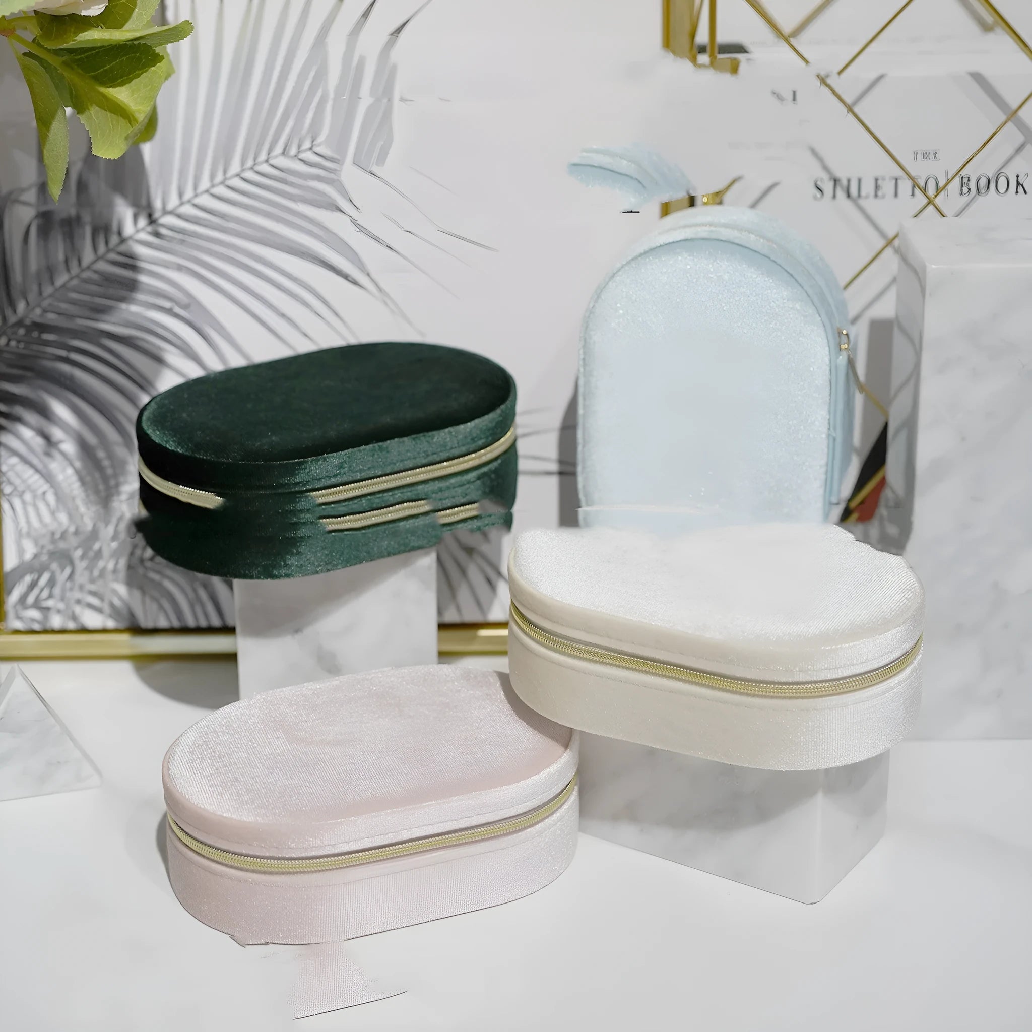 Oval shaped velvet jewellery storage box with flannel interior and inner hook, shown in lake blue.
