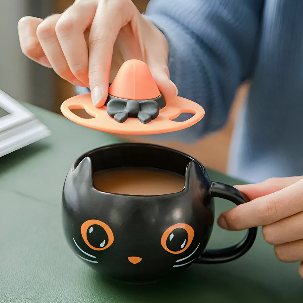 Black ceramic cat-shaped mug with pumpkin covered spoon on side