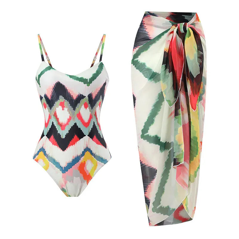 Women's printed two-piece swimsuit with matching hip skirt in striped gradient pattern.