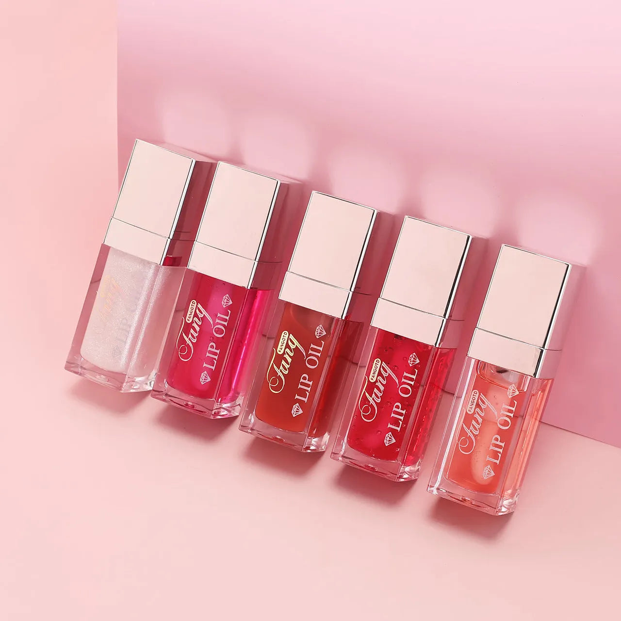 Five tubes of bright mint lip gloss lipstick in different shades on a white background.