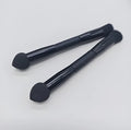 Double-headed black makeup brush with angled sponge and concealer brush on wooden handle