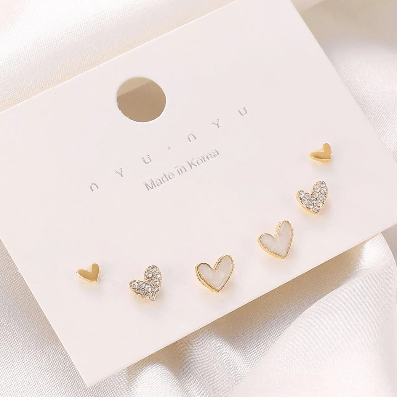 Three pairs of women's heart-shaped alloy earrings in coordinated set with electroplated finish