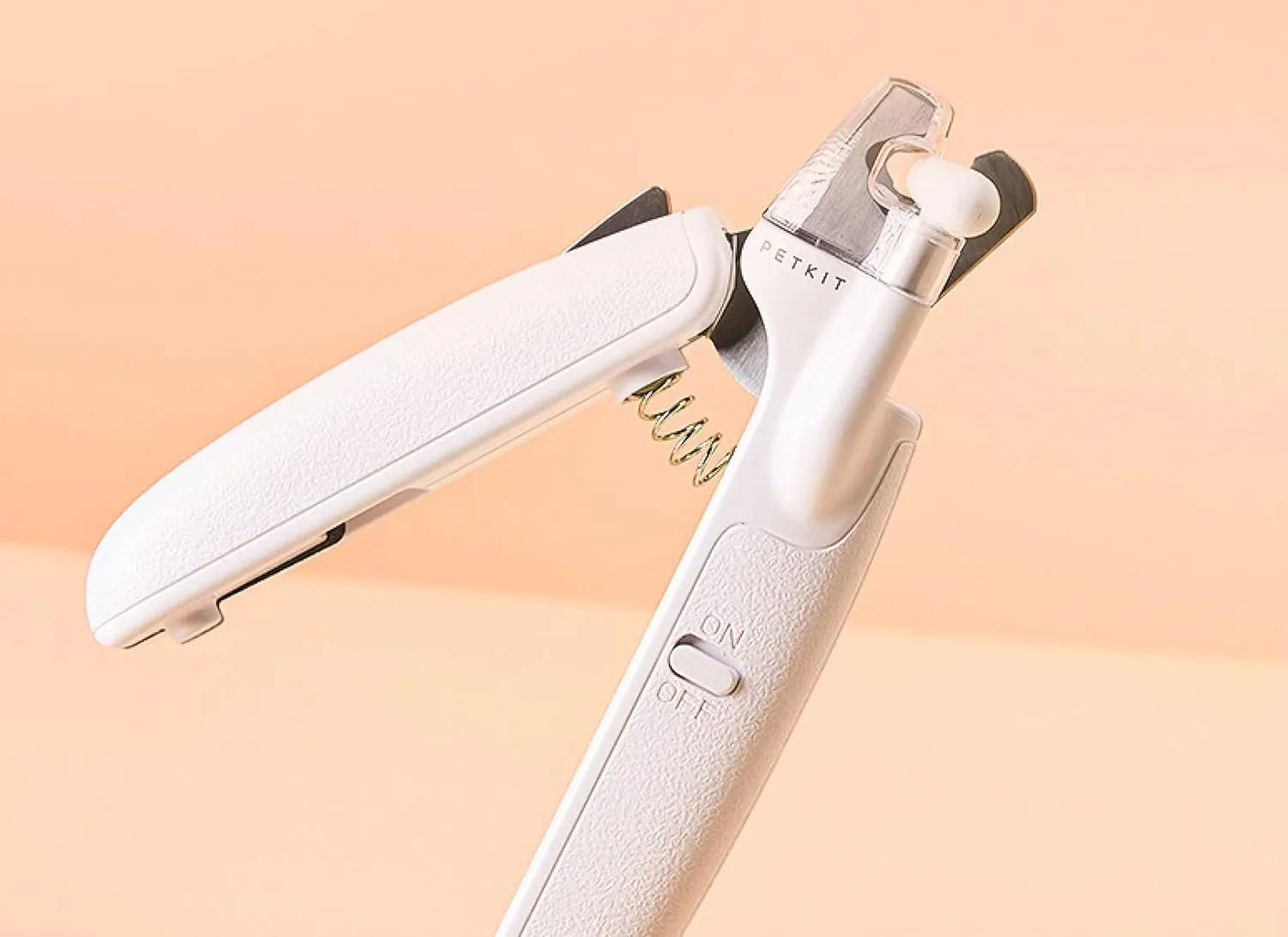 White pet nail clippers with LED light, triangular blade, and transparent anti-splash guard