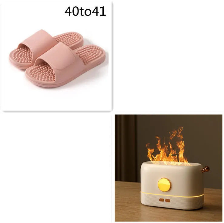 Black USB humidifier with simulated flame effect and mist output on a wooden desk
