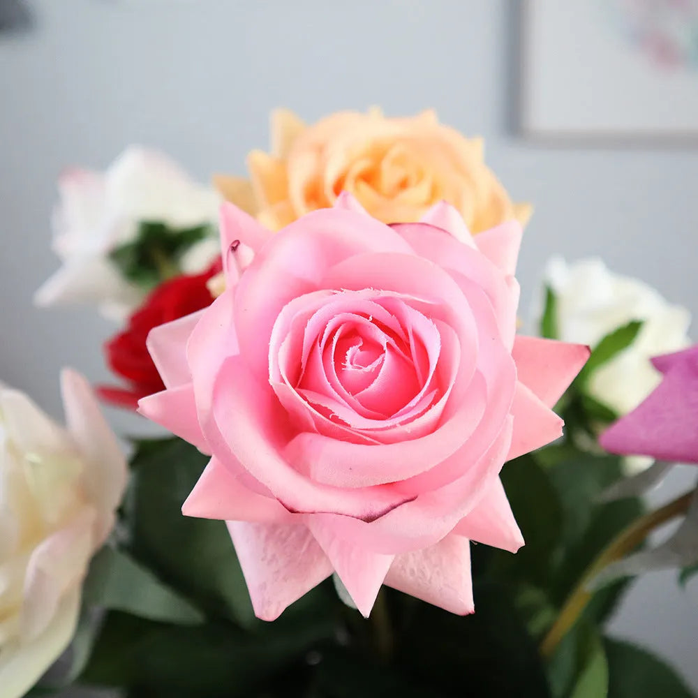 Artificial silk flower bouquet with red petals and green leaves measuring 42cm long