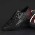 Men's black and white leather pumps with elastic band, round toe, and flat vulcanised rubber sole.