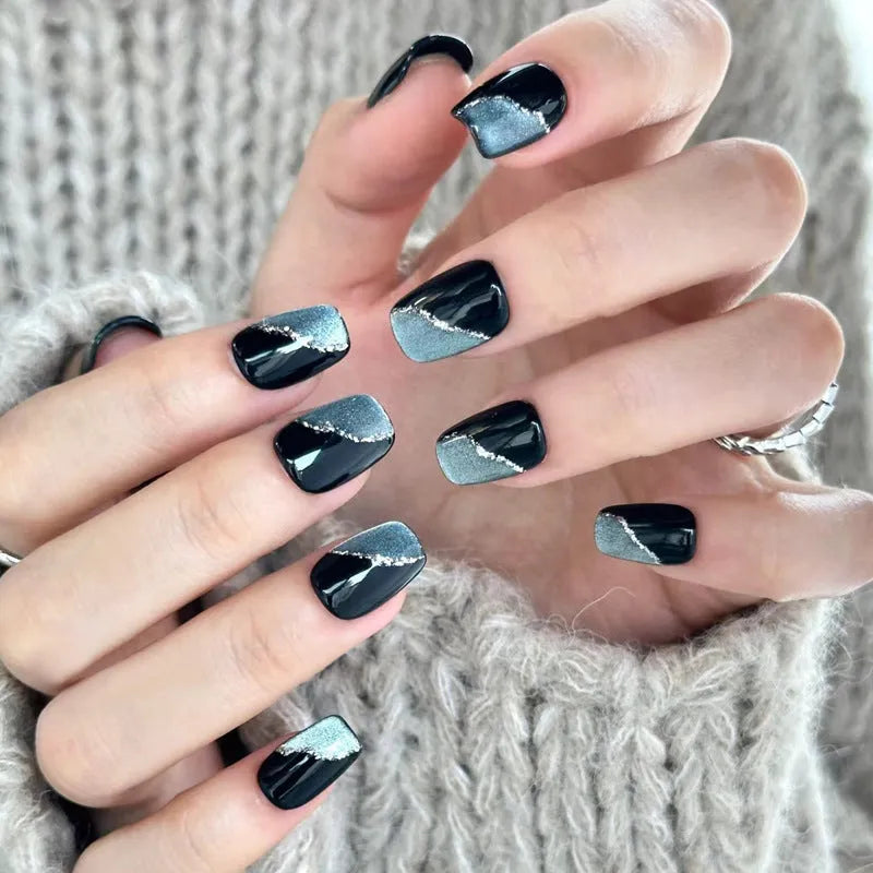 Set of short, colourful fake nails for girls with adhesive tabs on a pink background.