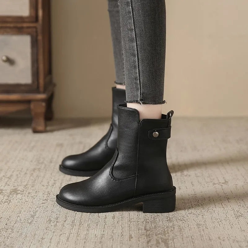 Black women's ankle boots with side zip, round toe, and low rubber sole