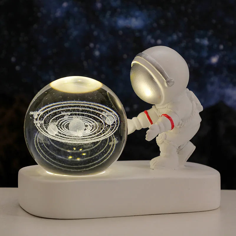 Clear resin crystal ball night light with glowing astronaut pattern on USB base