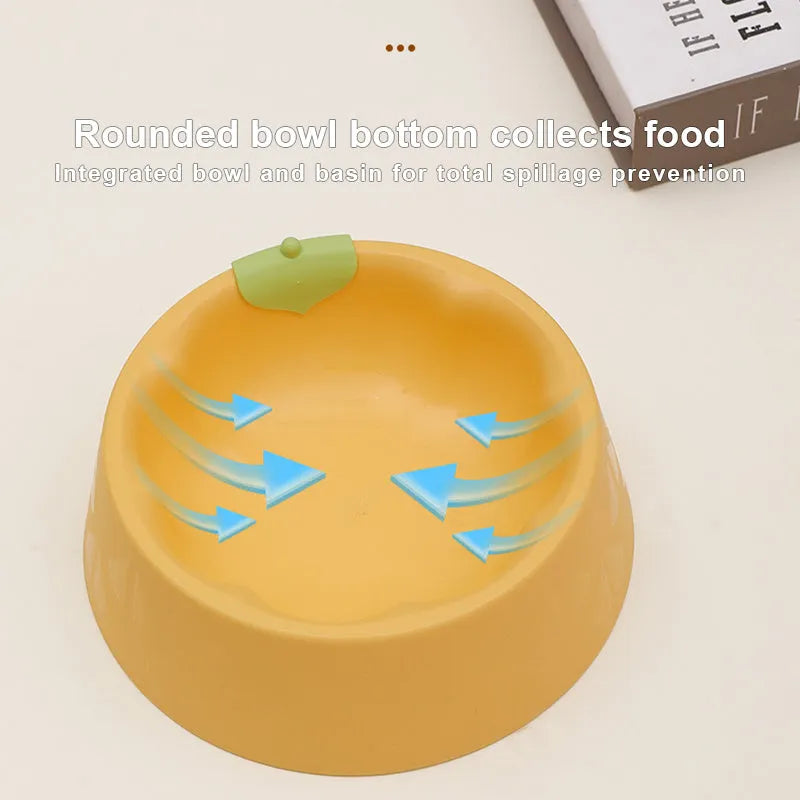 Green and yellow plastic double pet bowl for food and water on a flat surface.