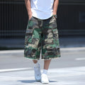 Man wearing loose-fit cropped camouflage shorts in retro American workwear style.