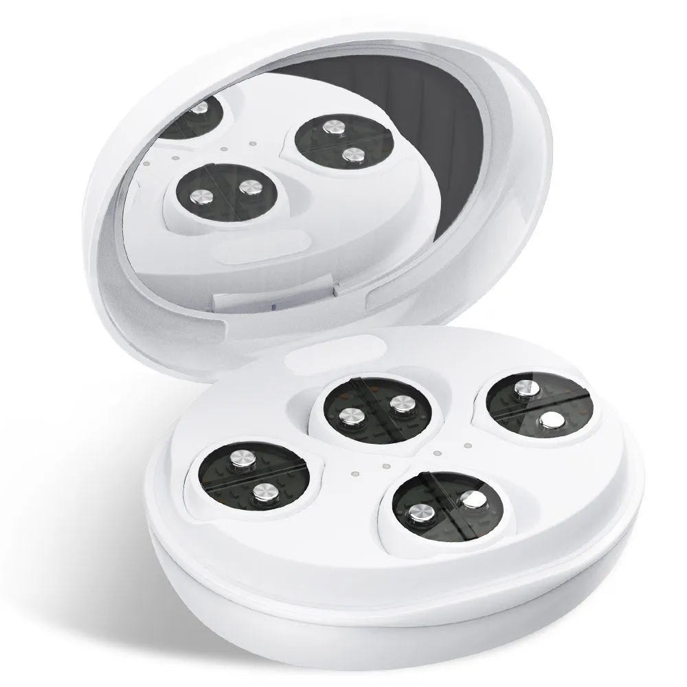 White wireless red light EMS facial and eye massager device on a table