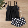 Women's black polka dot high-waisted boxer swimsuit laid flat, showing brief style and print detail.