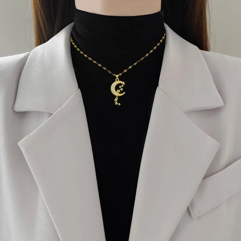 Geometric moon pendant necklace with tassel detailing in stainless steel and copper construction