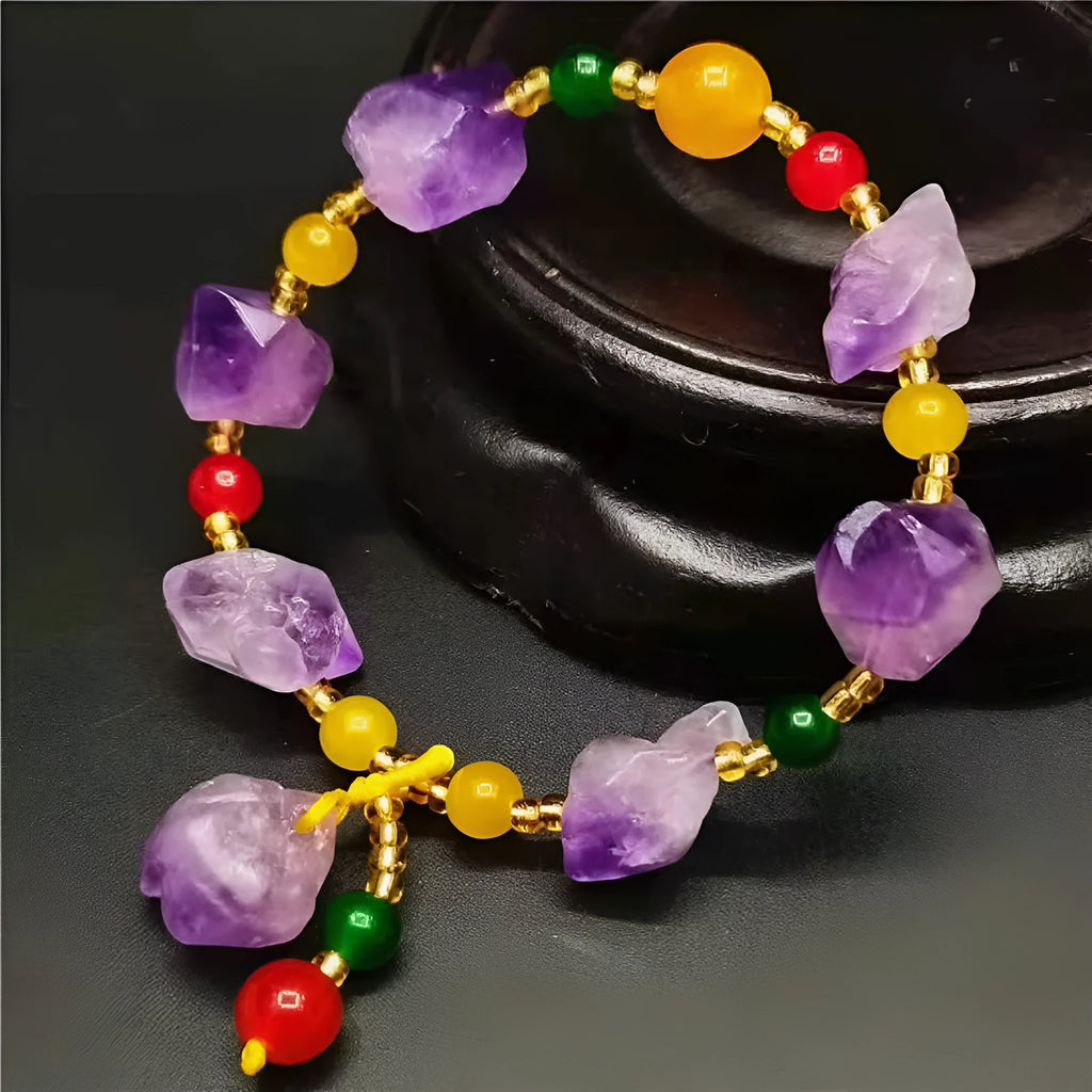 Close-up of a natural-shaped amethyst bead bracelet for women with a fu charm.